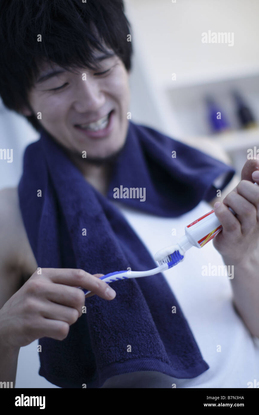 Man Putting Toothpaste on Toothbrush Stock Photo - Alamy