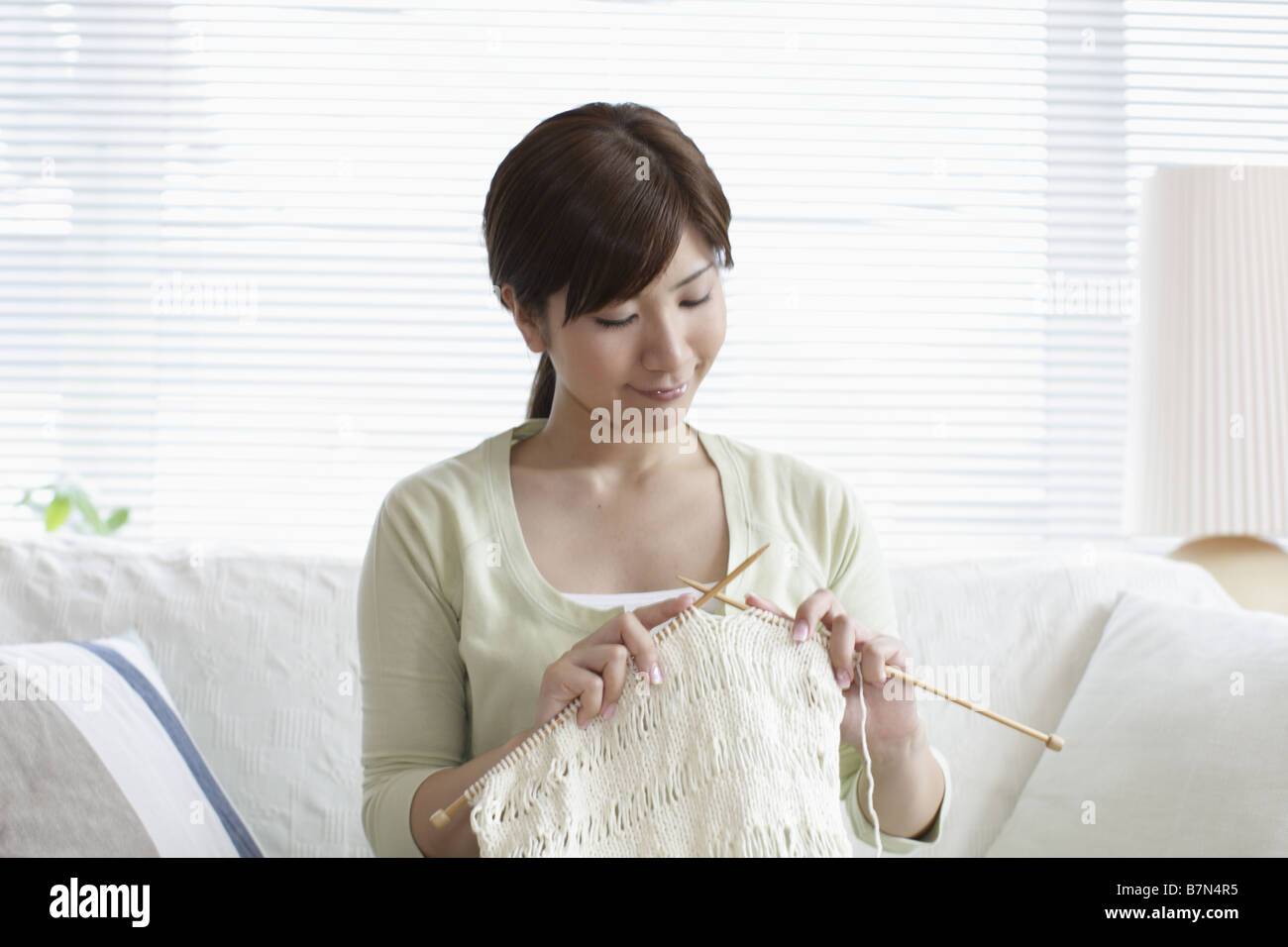Woman on Sofa Knitting Stock Photo - Alamy