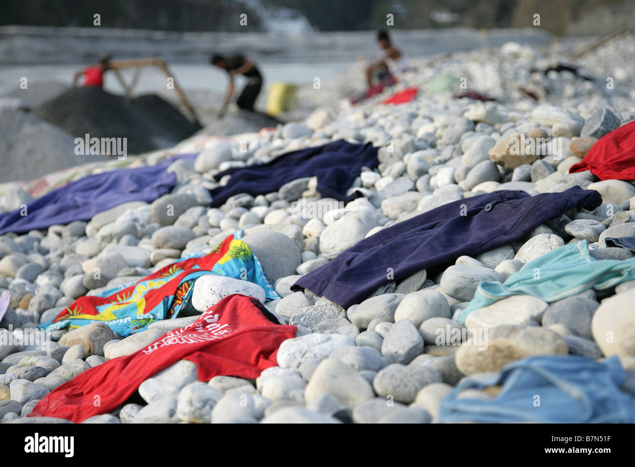 Clothes drying on stones Stock Photo - Alamy