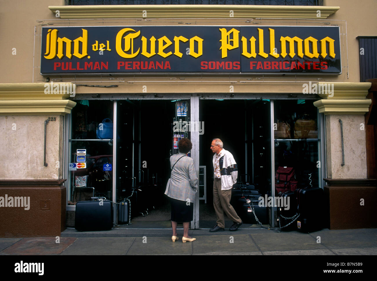 tourists, man and woman, couple, shoppers, shopping, buying luggage