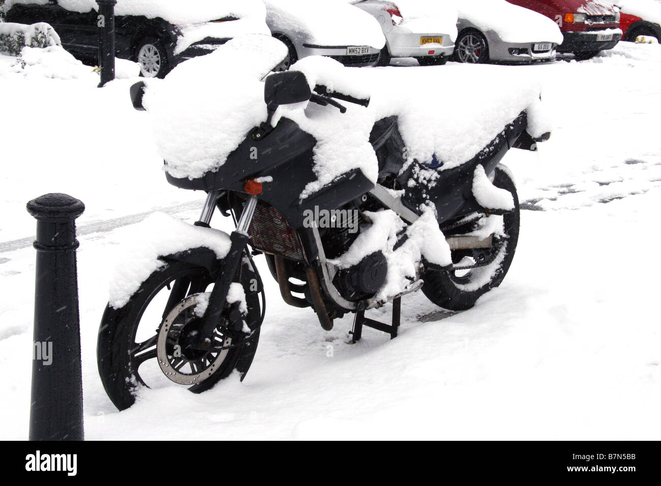 Motorbike covered in snow Stock Photo