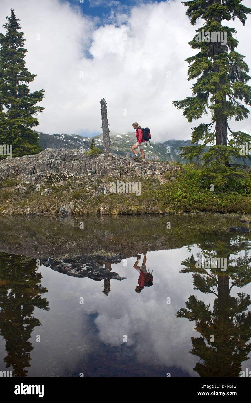 BRITISH COLUMBIA - Hiker above a small tarn in the Forbidden-Plateau Paradise Meadows area of Strathcona Provincial Park. Stock Photo