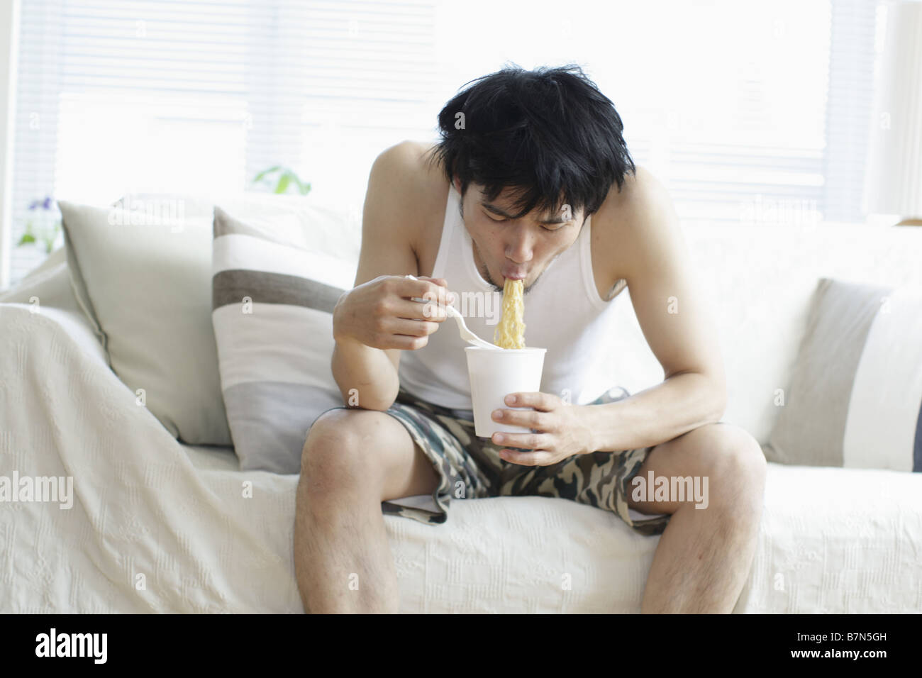 Man Eating an Instant Chinese Noodles Soup Stock Photo Alamy