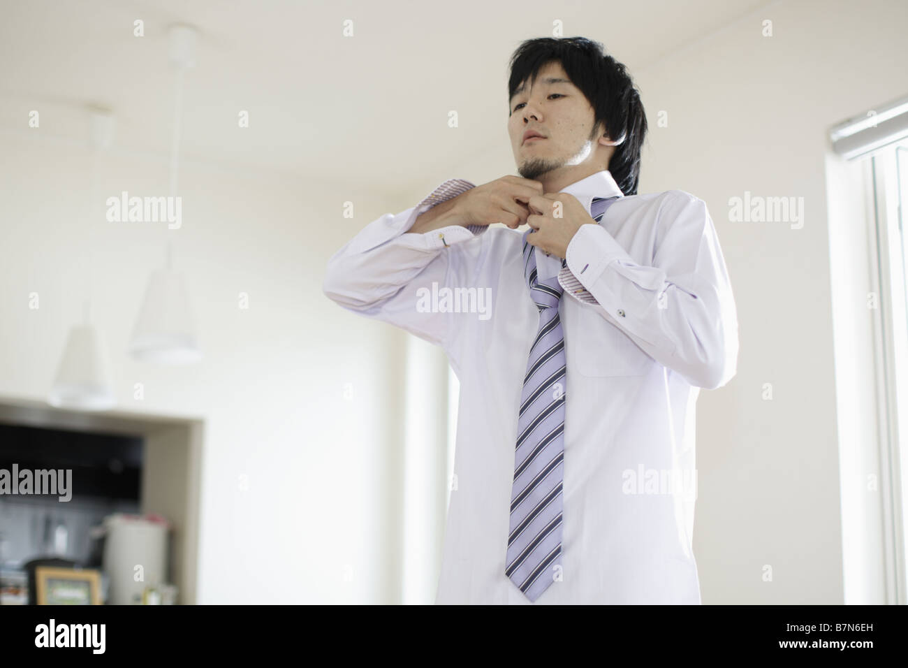 Man Adjusting His Tie Stock Photo - Alamy