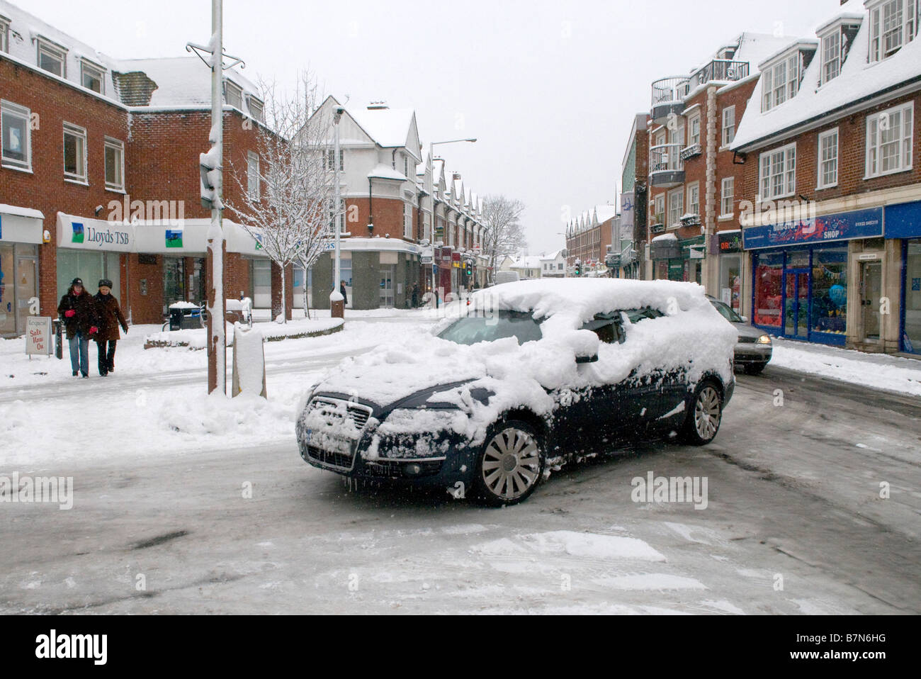 Car covered in snow, driving through Weybridge, Surrey Stock Photo Alamy