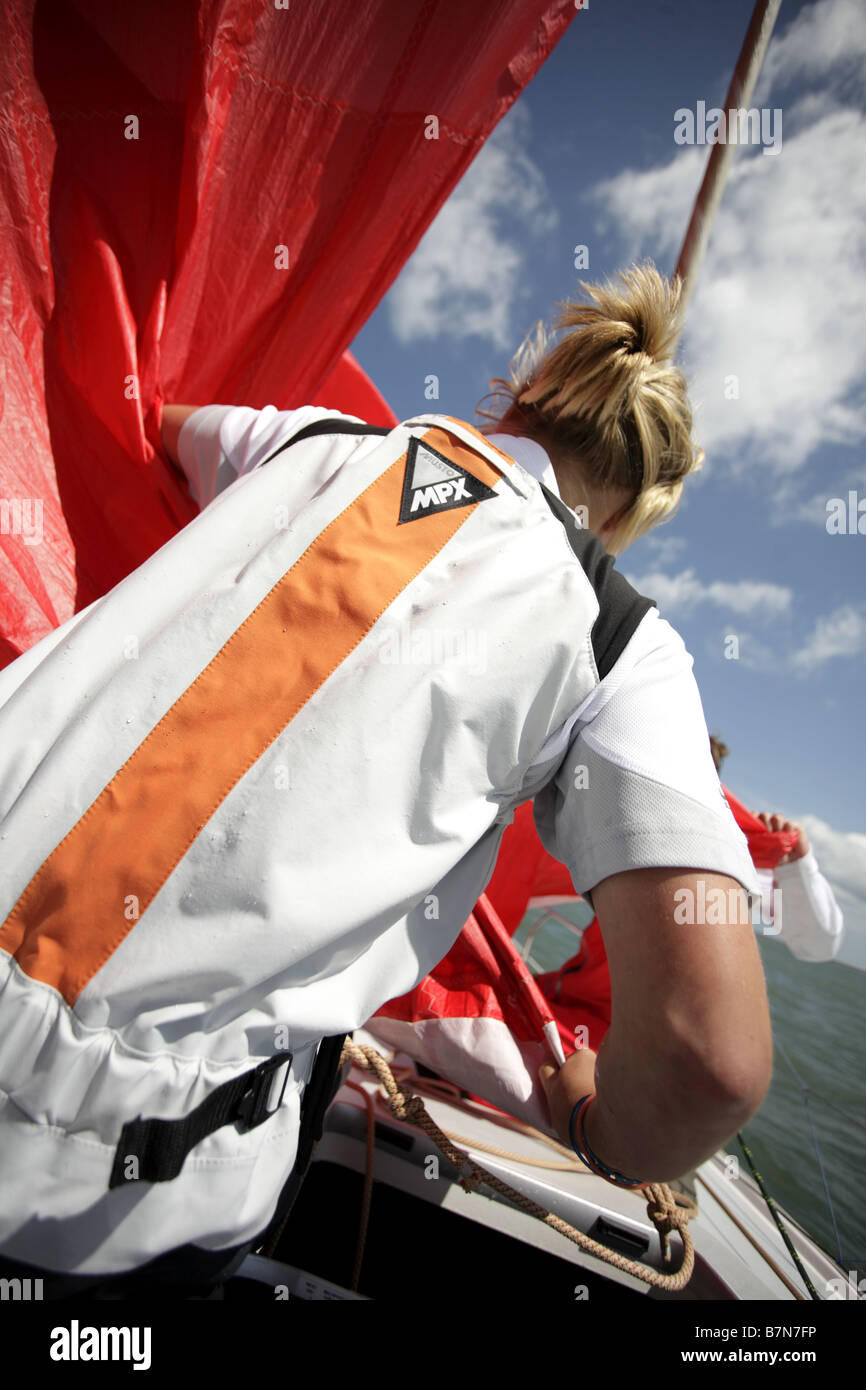 white,European female sailor, sailing a Yacht on the Solent,UK. Stock Photo
