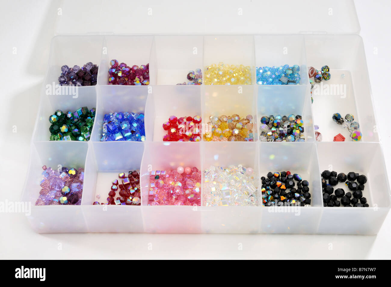 A partitioned plastic container full of Swarovski crystal beads for jewelry-making. USA. Stock Photo