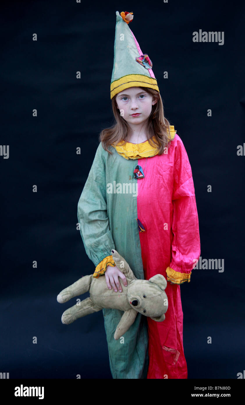 Small girl in vintage clown circus costume with teddy bear Stock Photo Alamy