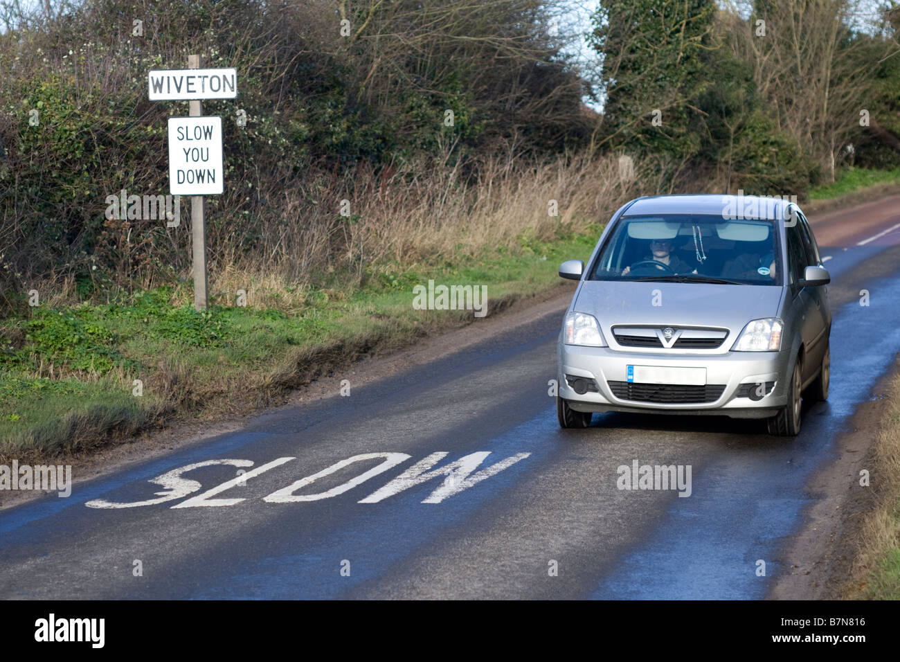 Slow you down road sign Stock Photo - Alamy