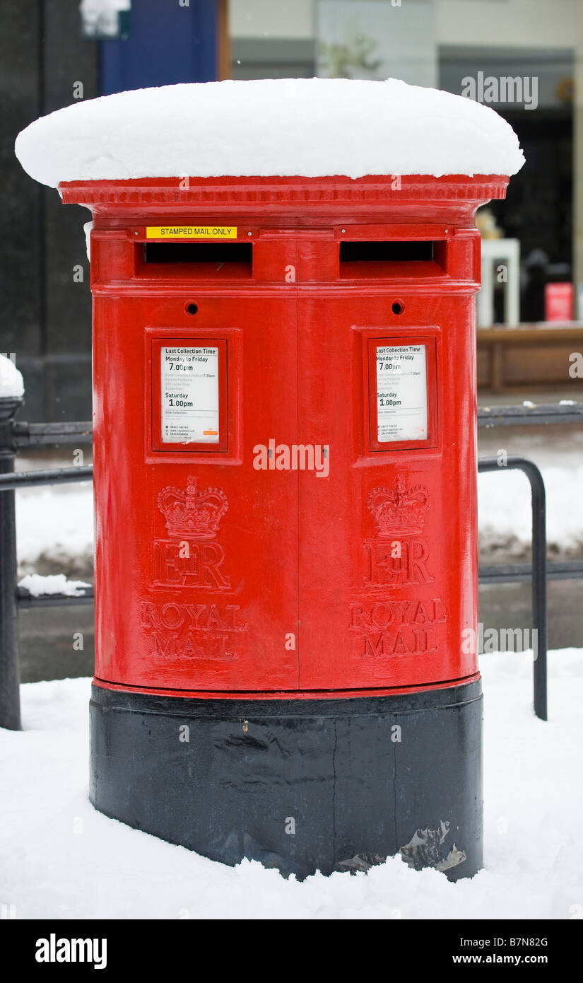 Red Royal Mail box under a thick layer of snow, Richmond, London, UK Stock Photo