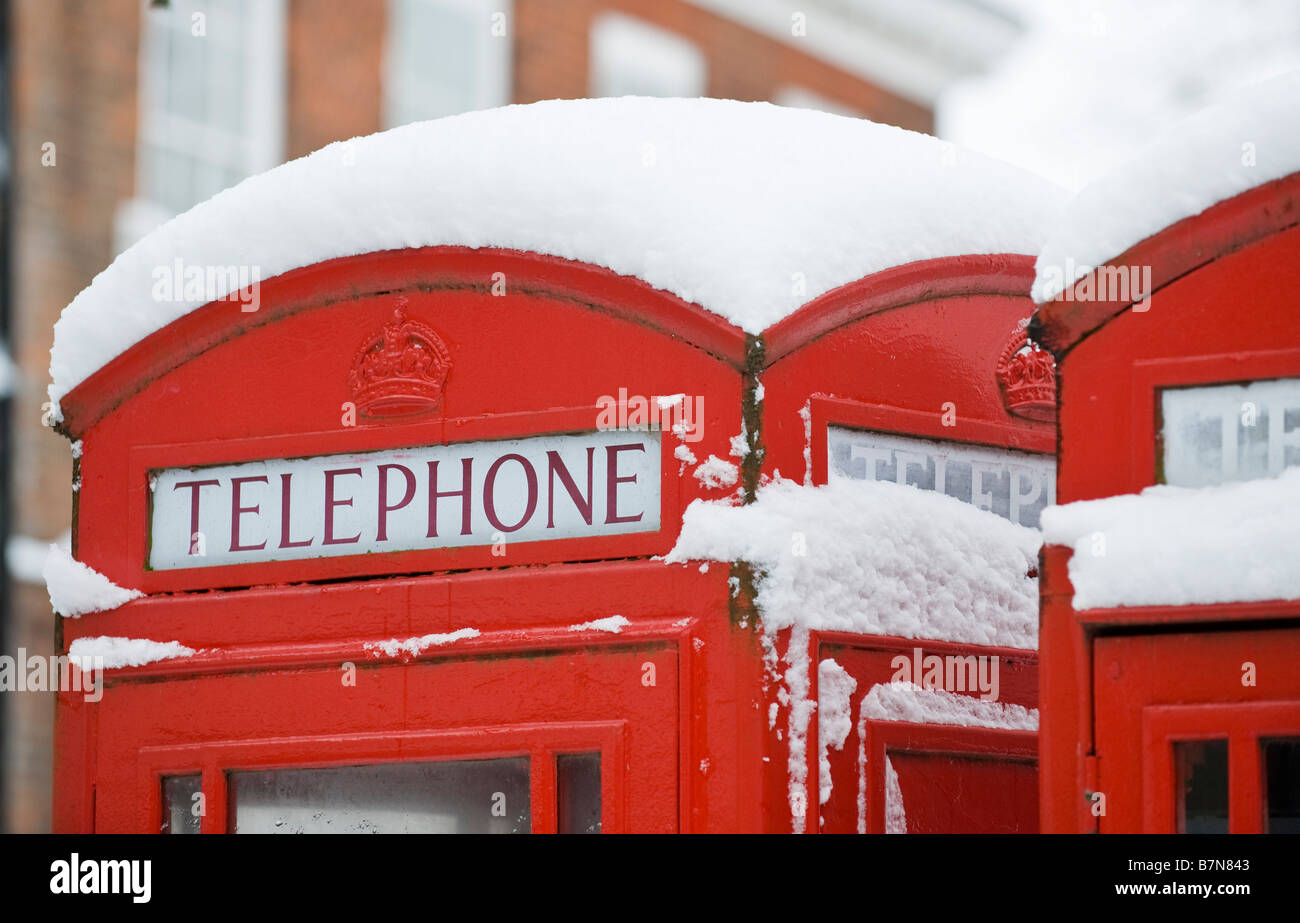 A thick layer of snow on top of red telephone boxes, Richmond, London, UK Stock Photo