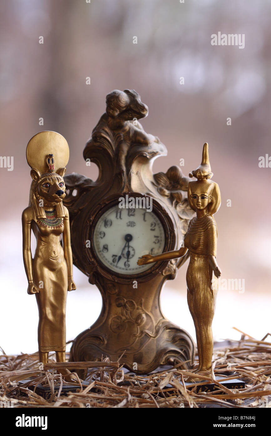 Antique French clock with egyptian female mummy statues Stock Photo