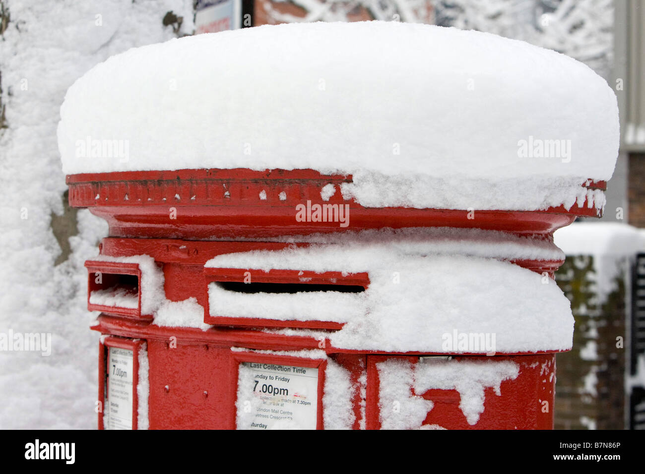 Snow Scenes in the Docklands Area of London February 2009 Red Post Box