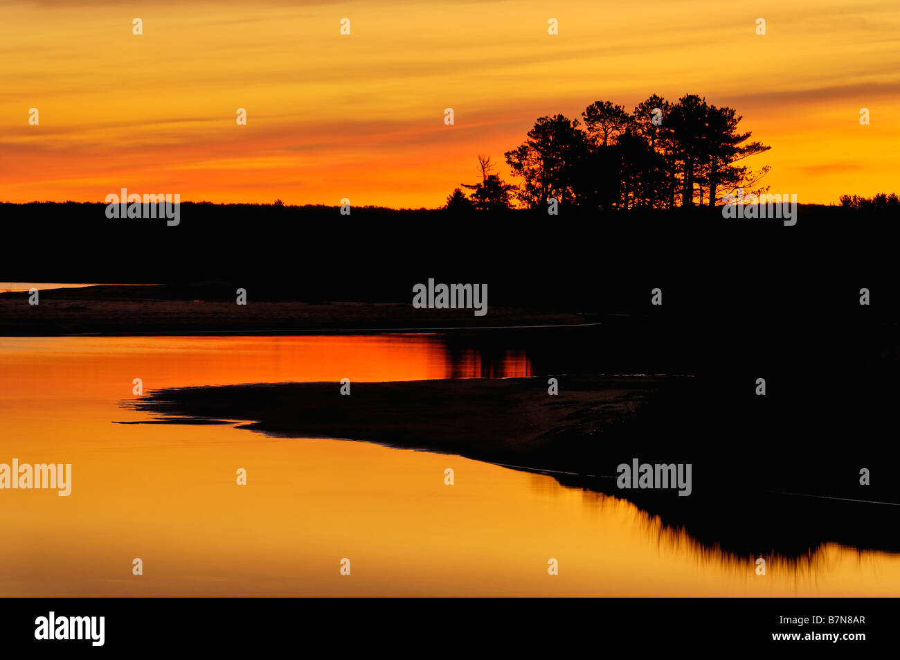 Sunrise Reflected on Au Train River where it Flows into Au Train Bay on Lake Superior Michigan Stock Photo