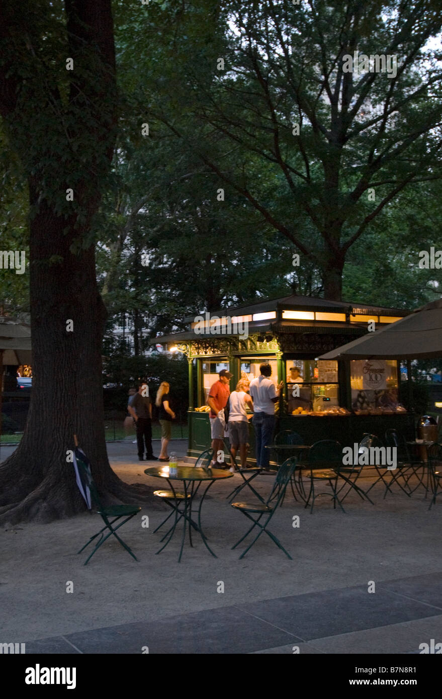 People buying from a concession stand in Central Park NYC at dusk Stock Photo
