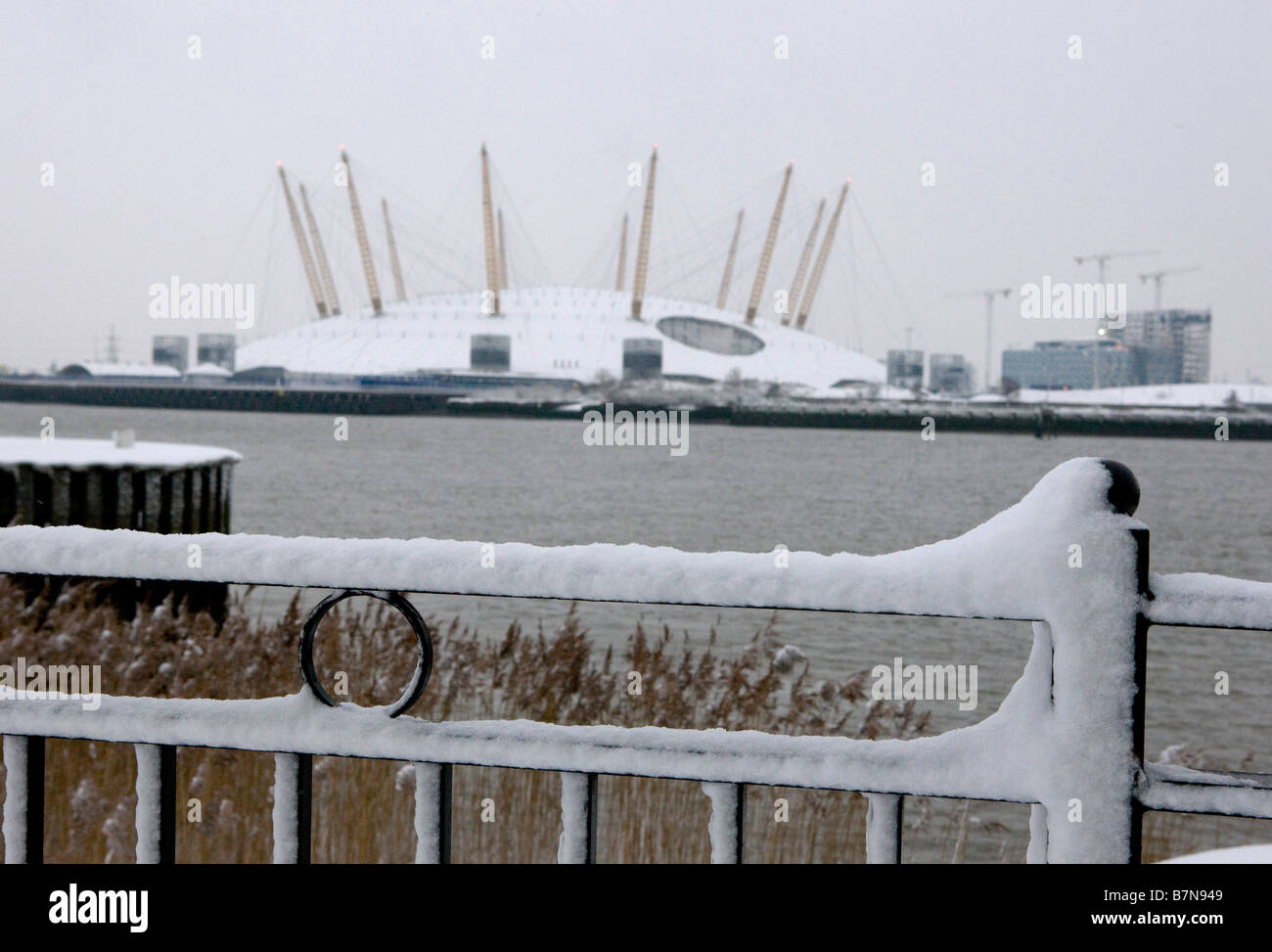 Snow Scenes in the Docklands Area of London February 2009 Snow covered fence looking across the River Thames to the O2 Stock Photo