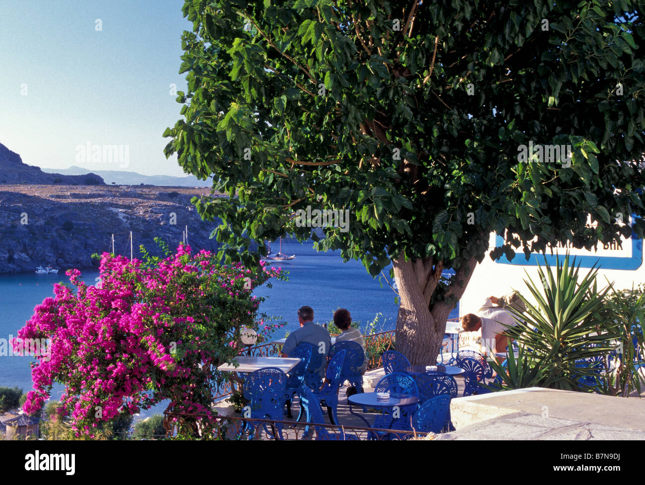 Guests at a taverna in Lindos, Rhodes Island, Greece. Stock Photo