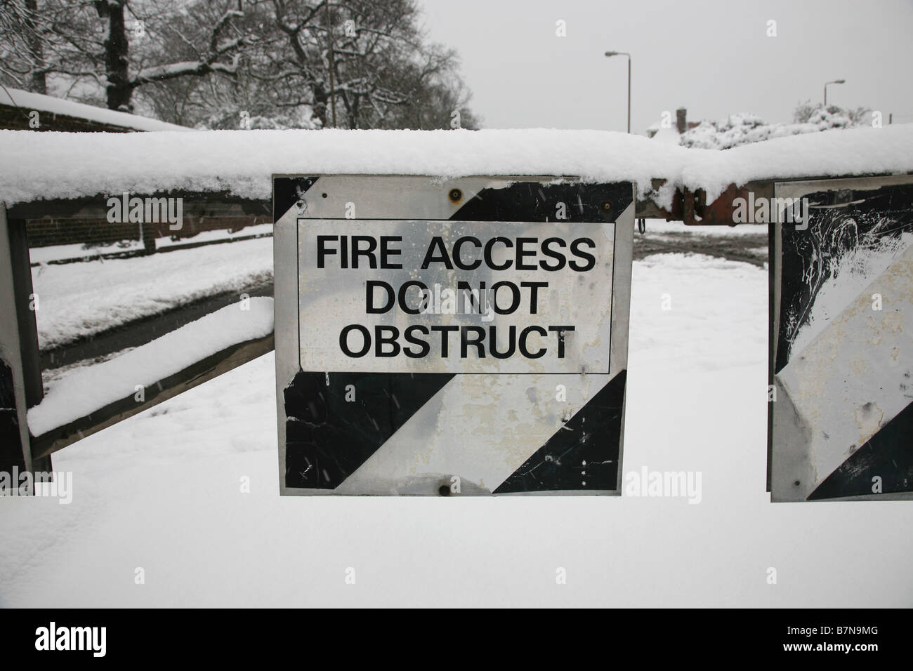 Fire access do not obstruct road sign covered in snow Stock Photo