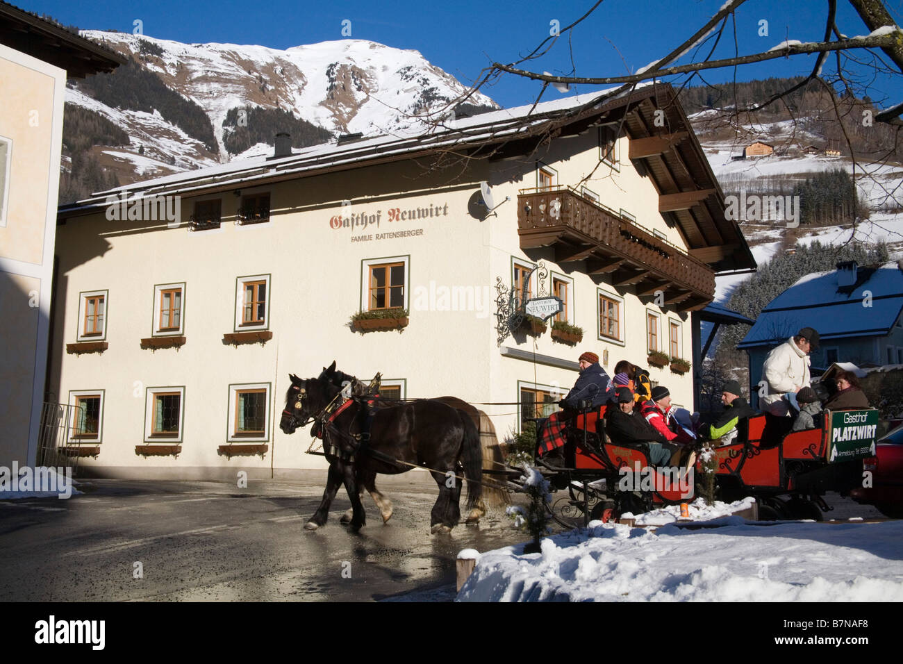 Rauris Austria EU January Group of tourists in a horse drawn sleigh on a tour of this traditional ski resort town Stock Photo