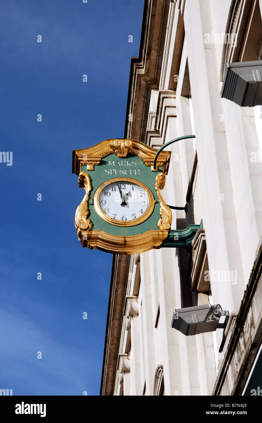The clock over the entrance to the Marks and Spencer store in Cheltenham UK Stock Photo