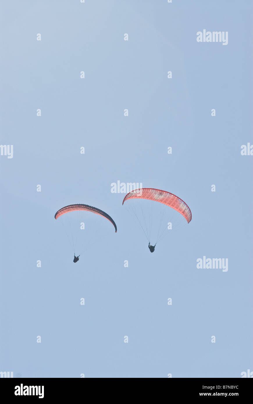 distant view of hang glider in sky Stock Photo