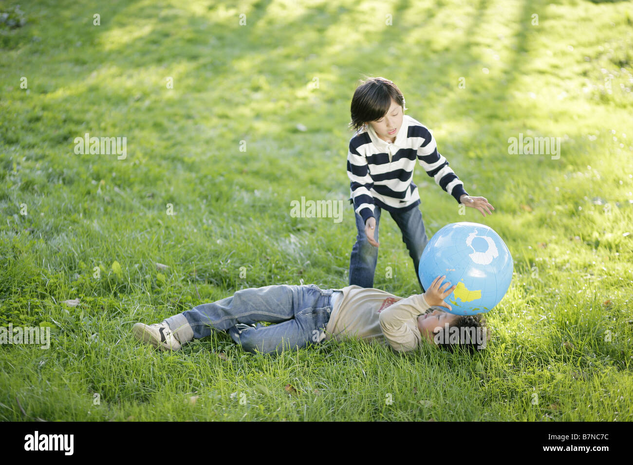 Boys playing with a ball Stock Photo - Alamy