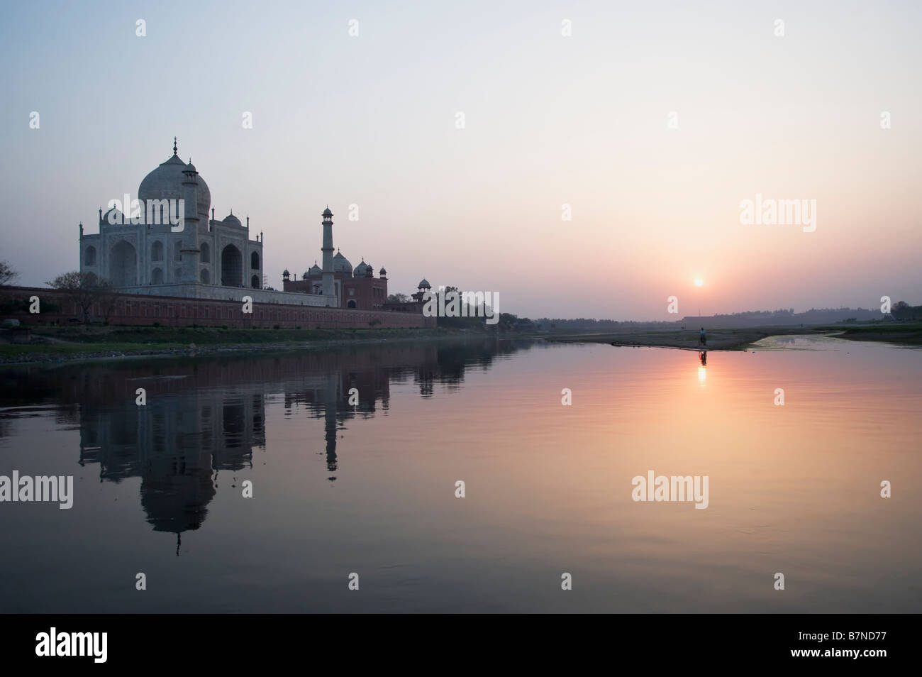 Taj Mahal reflecting in the Yamuna river at sunset Stock Photo