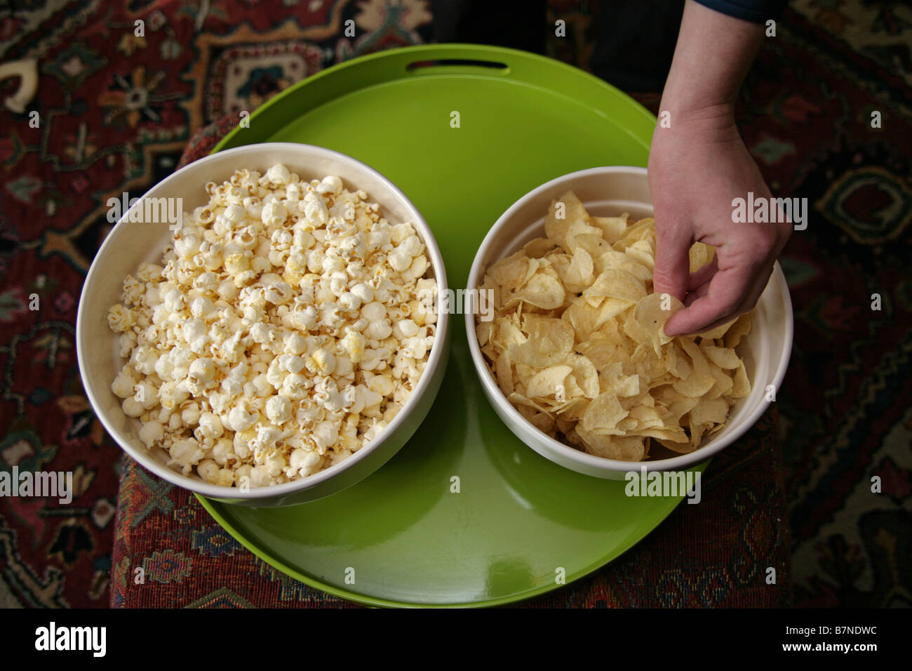 Popcorn and potato chips in snack bowls Stock Photo Alamy