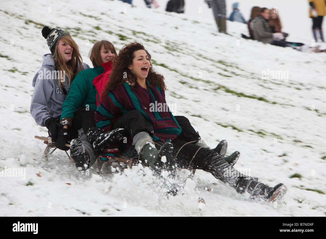 Teenagers play on new snowfalls at Alexandra Palace north London after schools have closed Stock Photo