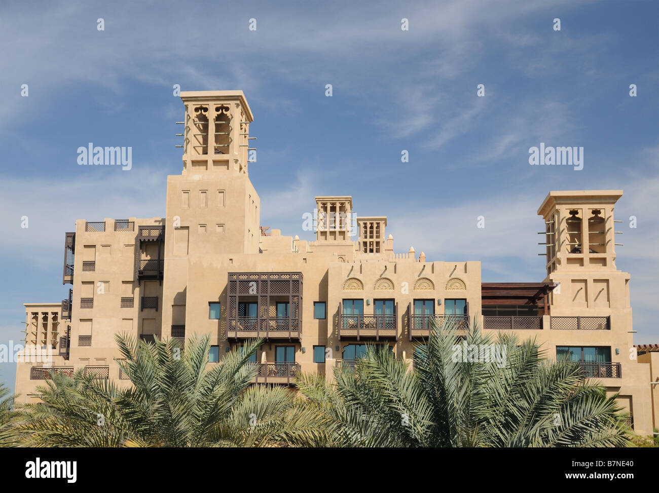 Building with traditional Arabic Wind Towers in Dubai Stock Photo