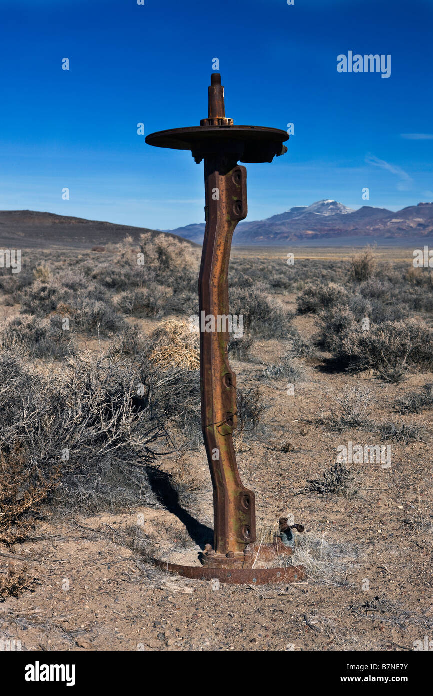 An abandoned and rusted axel planted vertically into the ground Black Rock Desert Gerlach Nevada Stock Photo