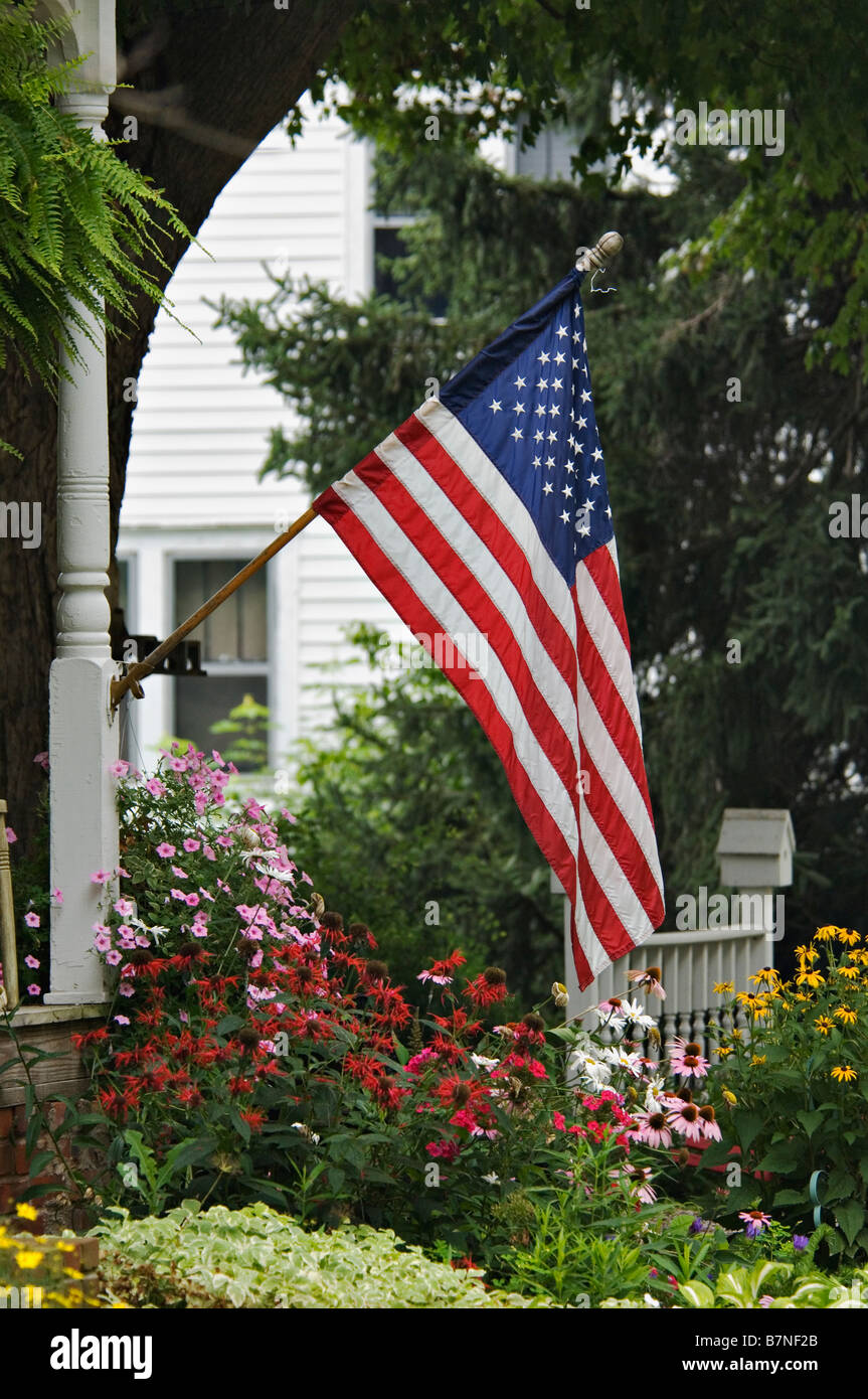 American Flag Displayed in Small Town Cottage Garden Georgetown Indiana Stock Photo