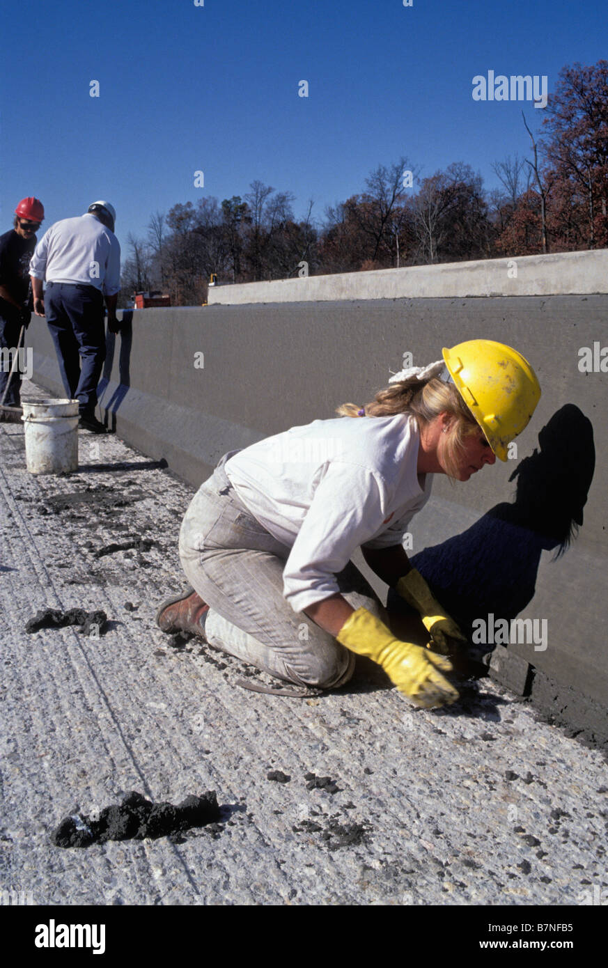 Female Construction Worker Smoothing Wet Concrete on New Interstate ...
