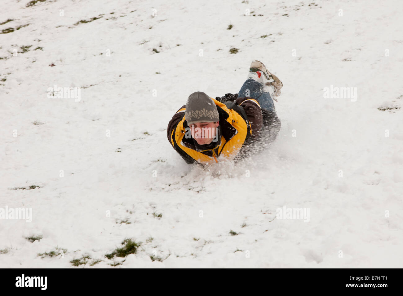 Teenagers play on new snowfalls at Alexandra Palace north London after schools have closed Stock Photo