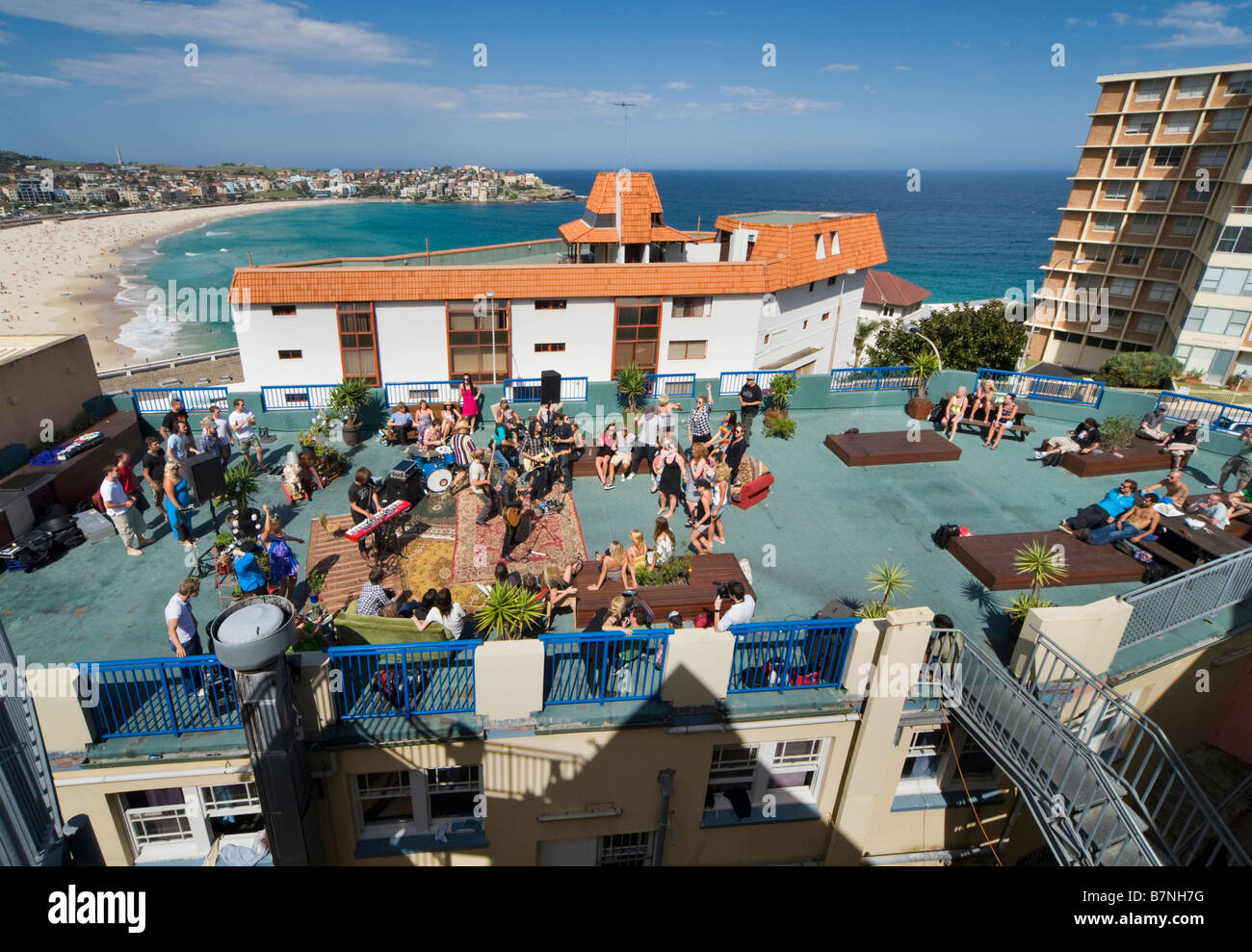 Party taking place on rooftop at Bondi Australia with Bondi beach behind Stock Photo