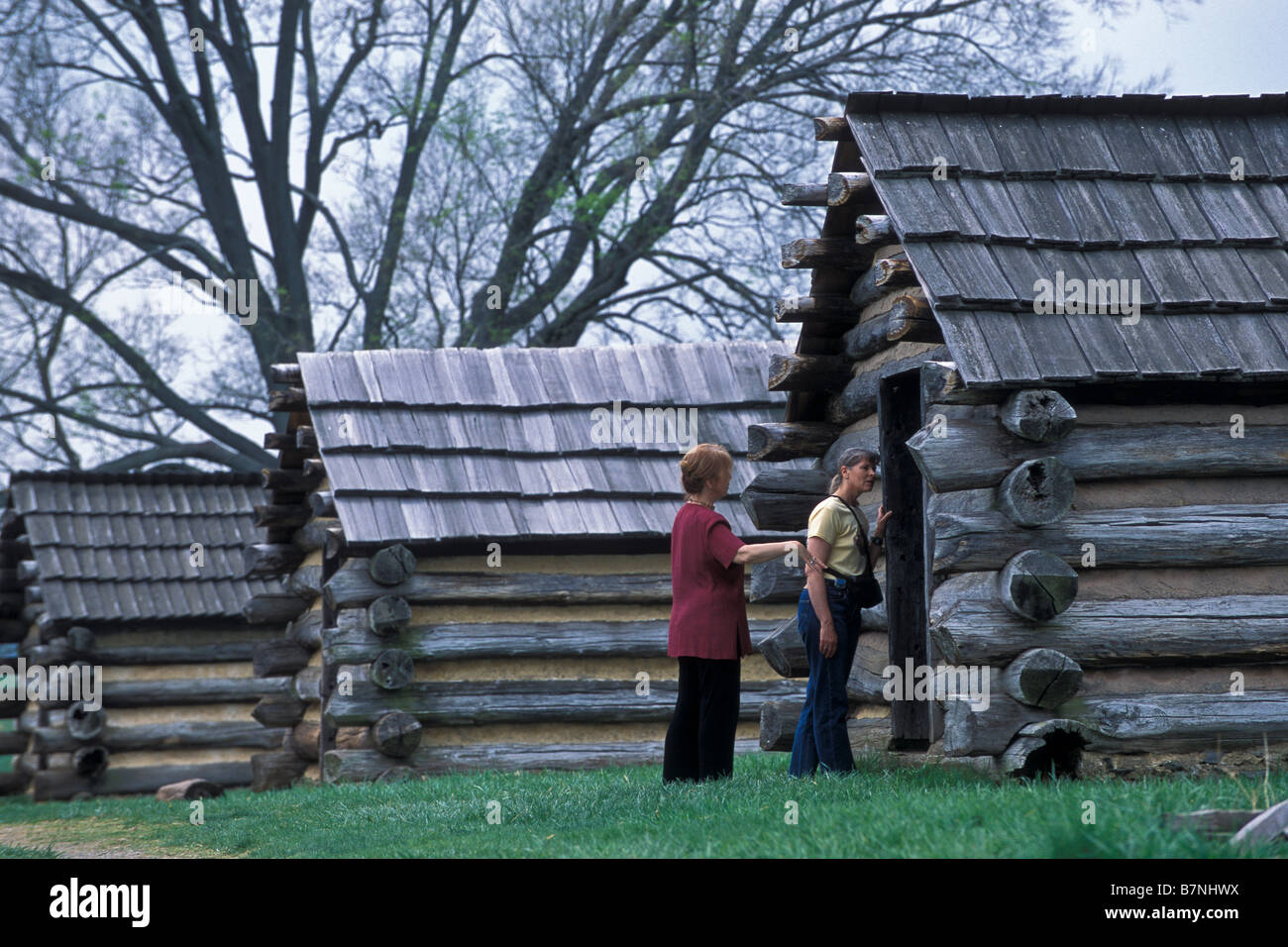 Visitors examine Muhlenberg Brigade huts, Valley Forge National Historical Park, Pennsylvania. Stock Photo