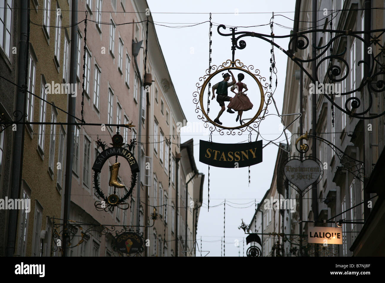 Traditional hanging iron signs over the shops in Getreidegasse in the
