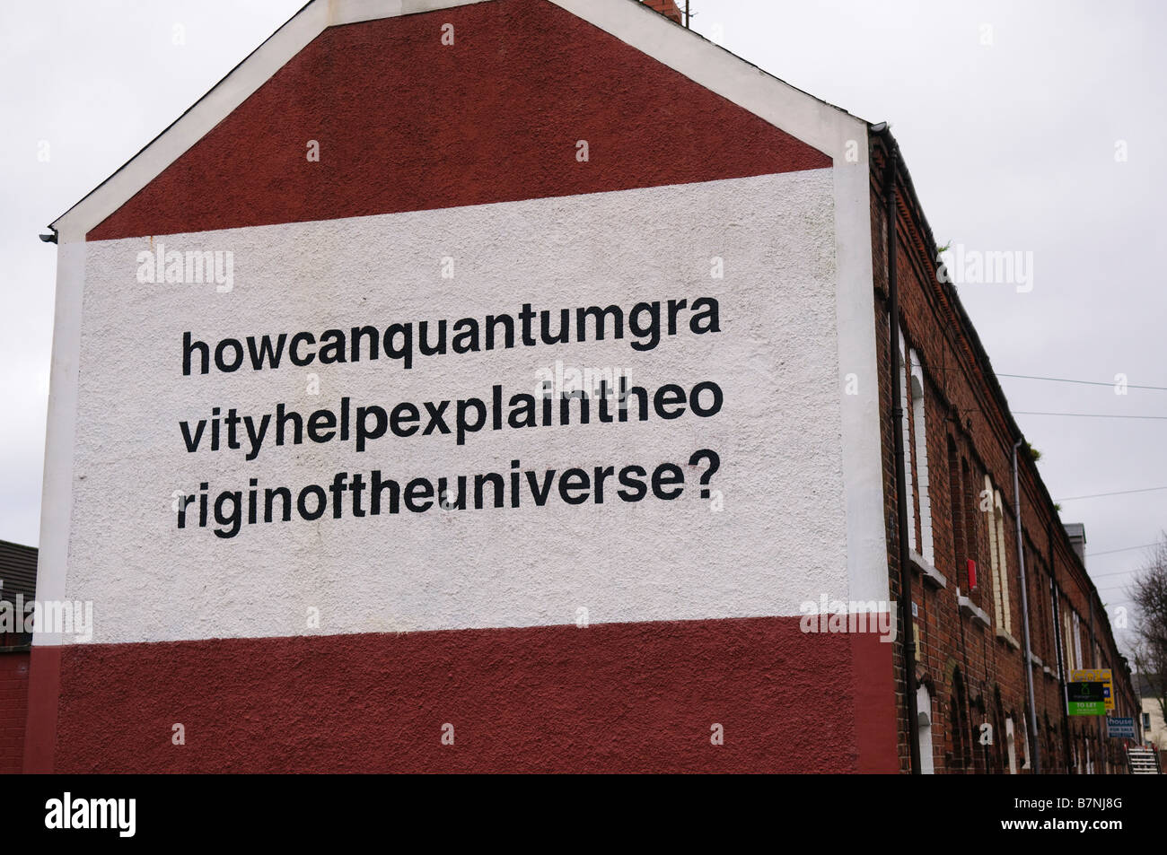 Mural in Belfast 'How can quantum gravity help explain the origin of the universe?' painted on side of terraced house Stock Photo