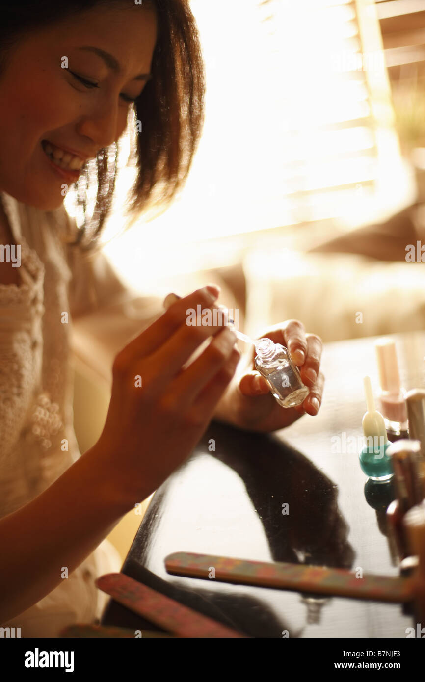 A woman painting her nails Stock Photo Alamy