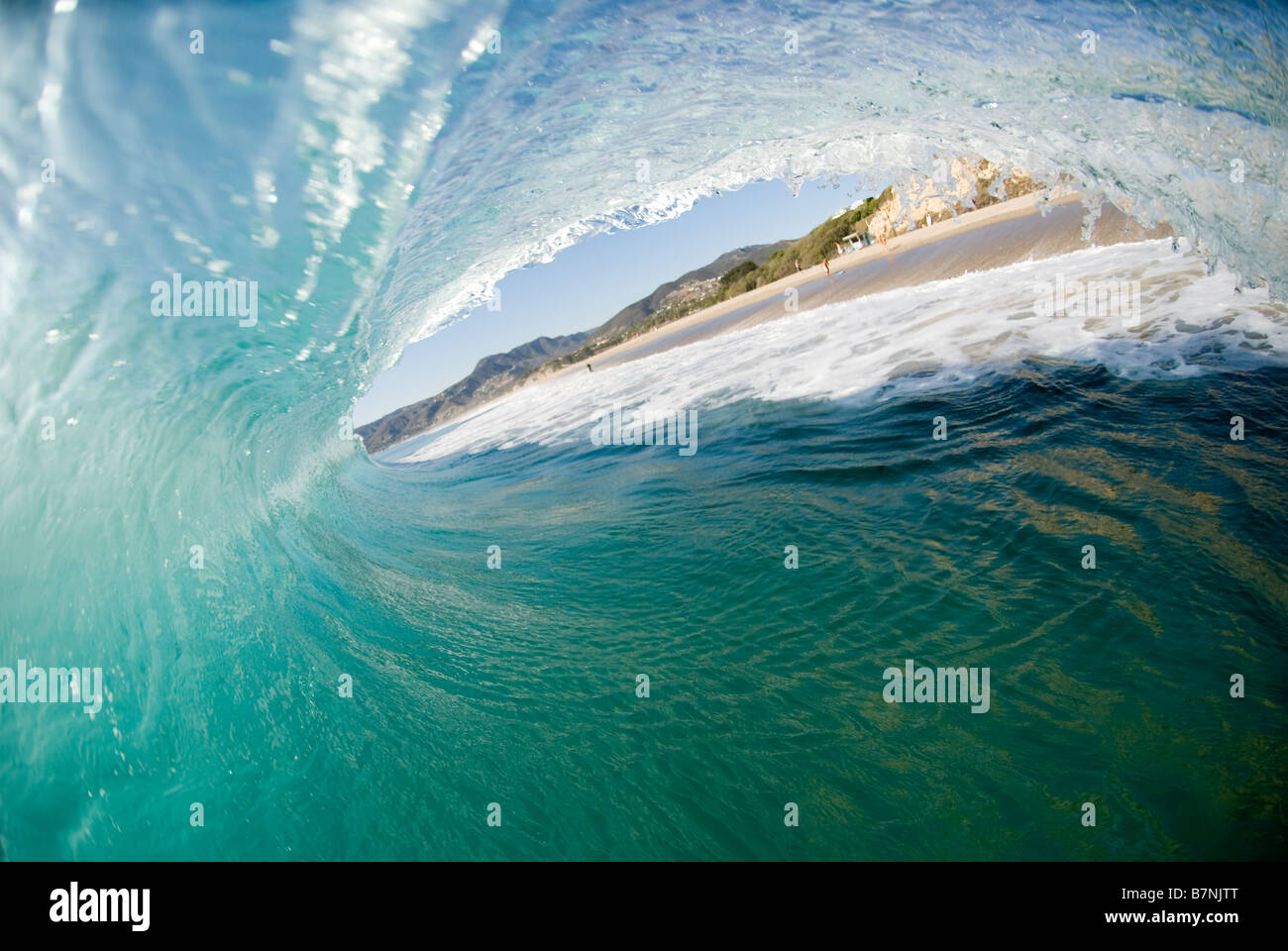 Inside a breaking wave at the beach. Zuma beach, California USA. Stock Photo