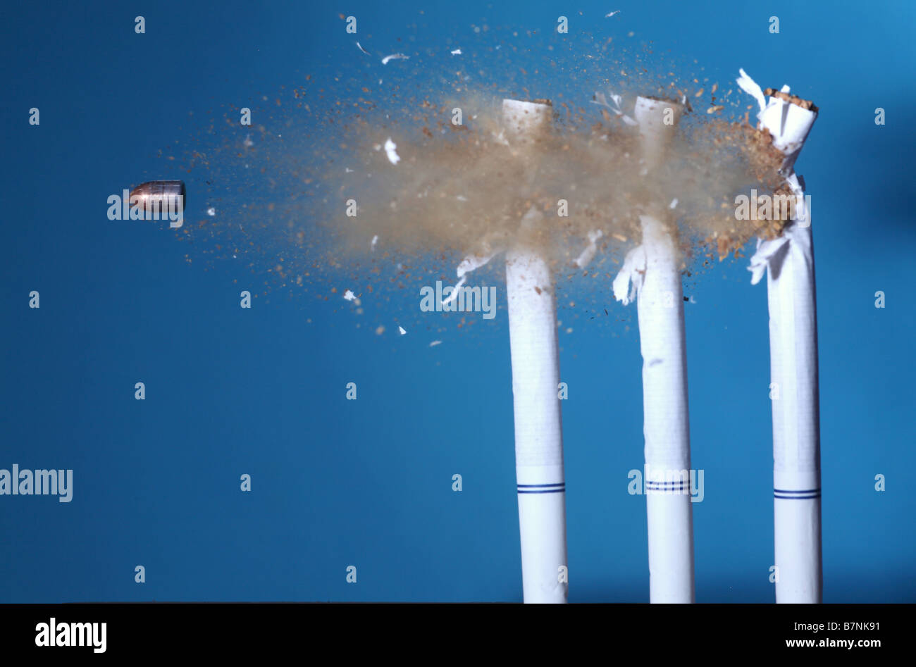 A bullet hitting cigarettes Stock Photo