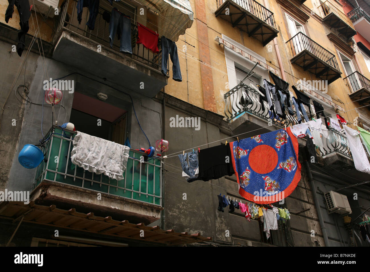Narrow street with washing linen in the historic centre of Naples, Italy. Stock Photo
