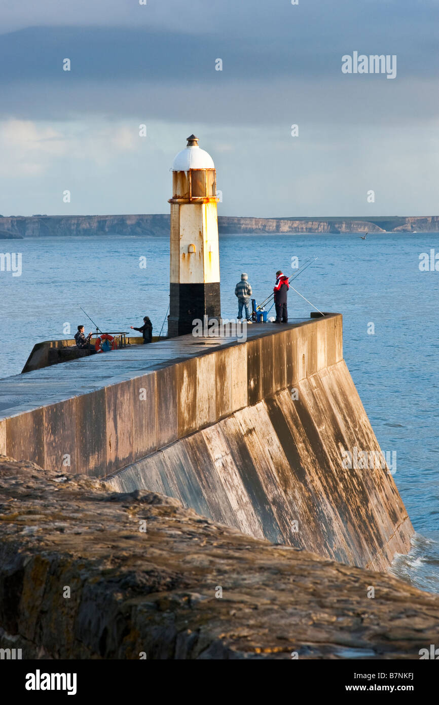 Fishing from the lighthouse wall Porthcawl South Wales UK Stock Photo