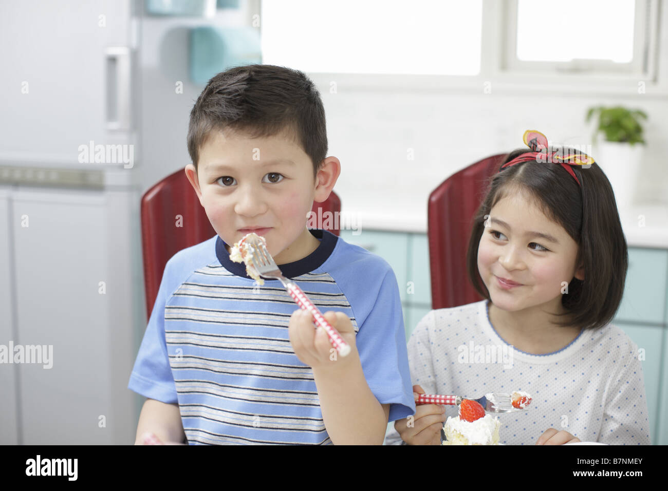 Children eating cake Stock Photo