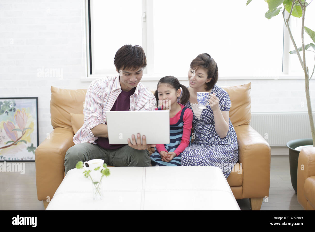 Family using computer Stock Photo - Alamy