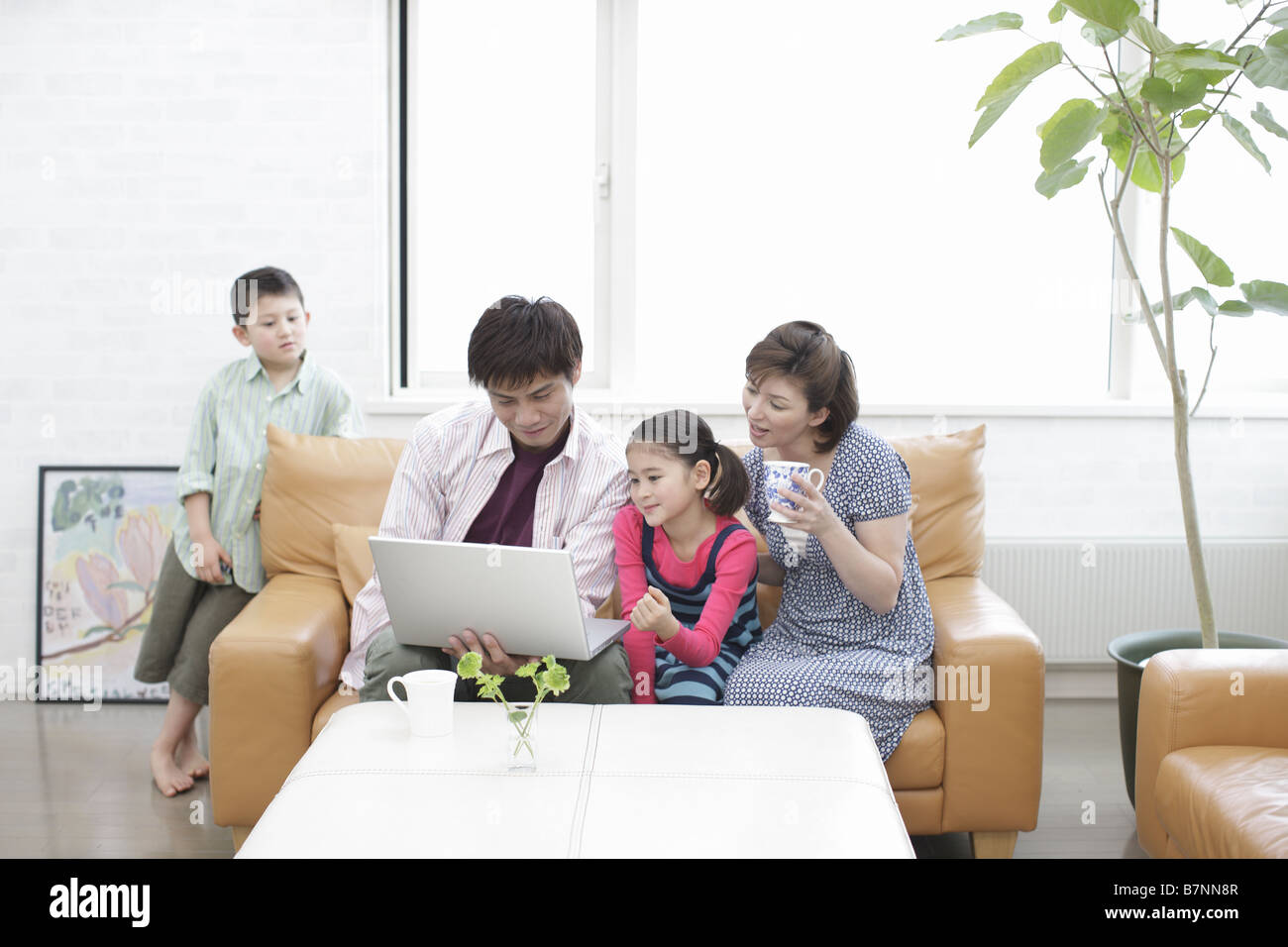 Family using computer Stock Photo - Alamy image.