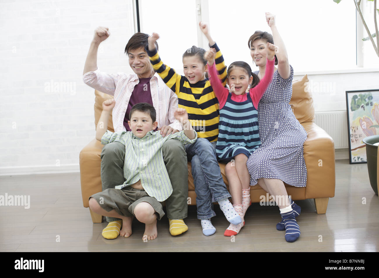 Family watching sports program Stock Photo