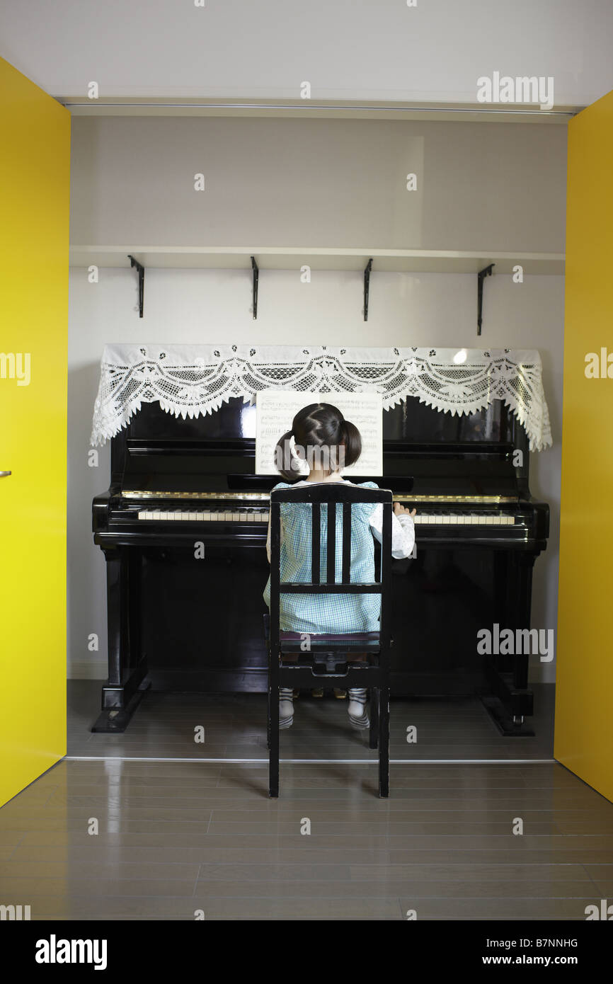 A girl playing the piano Stock Photo