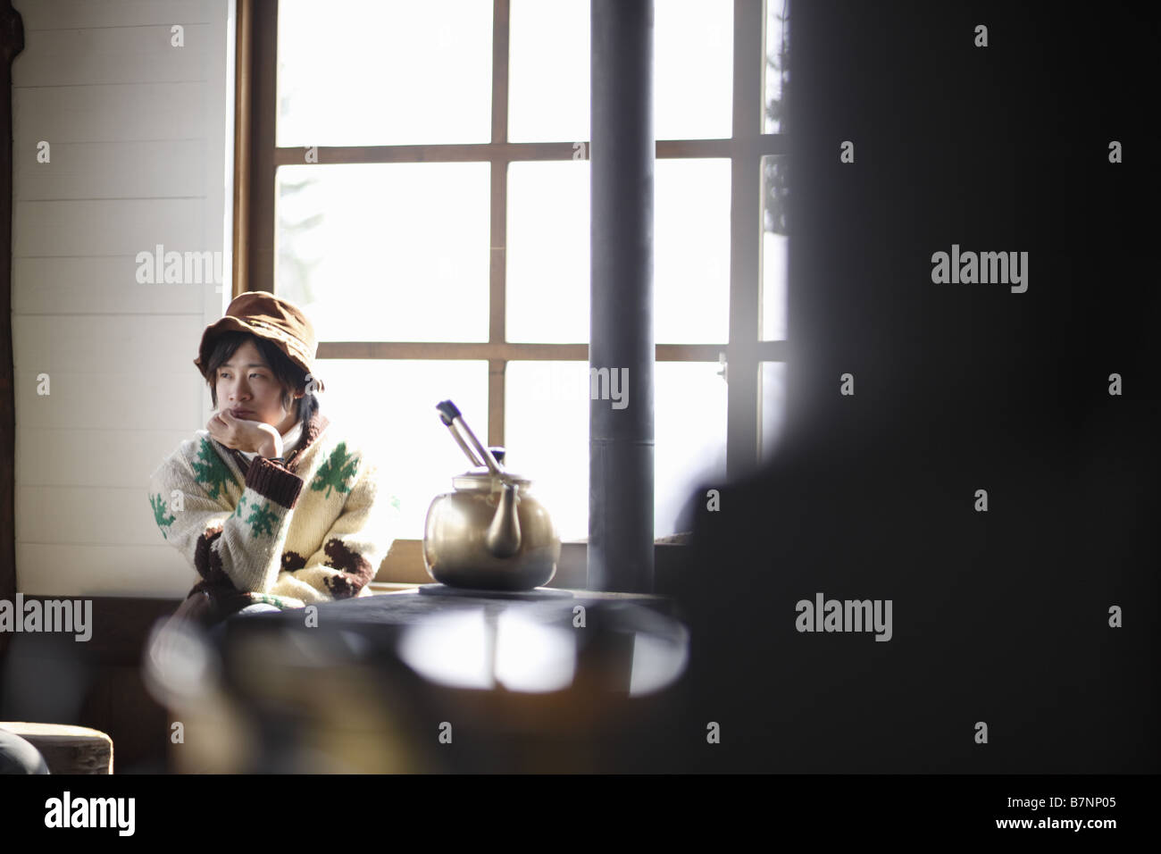 A young man resting chin on hand Stock Photo