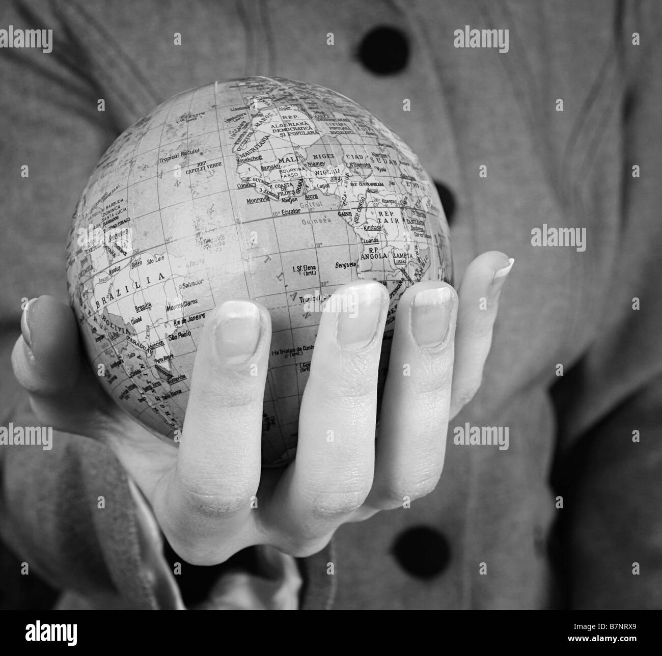 Globe in a girl's hands Macro image Stock Photo